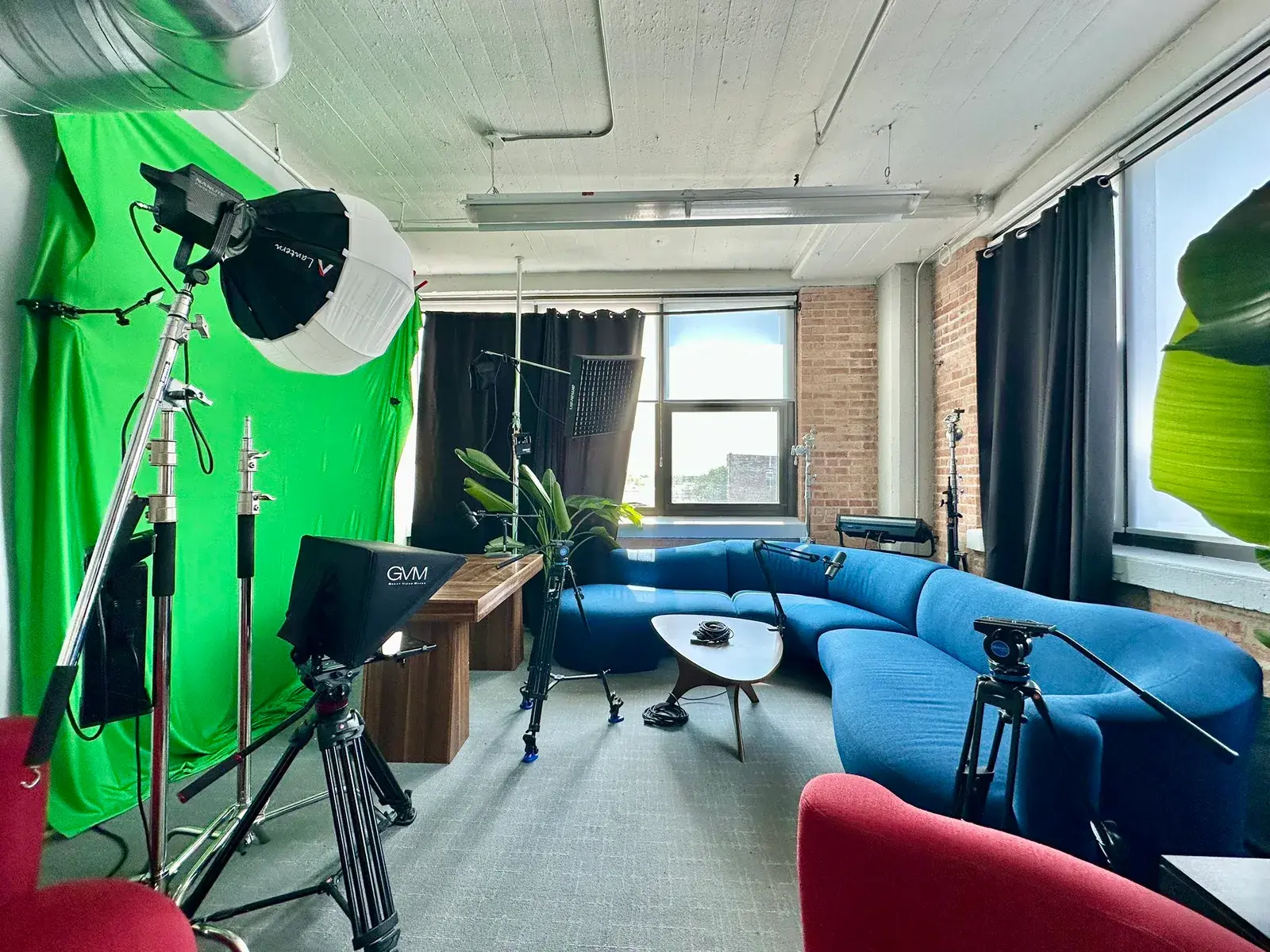 KW ONEChicago Content Studio with a green screen, production lighting, cameras, microphones, and podcast seating